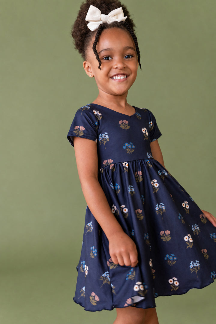 girl wearing navy fall flower bouquet dress