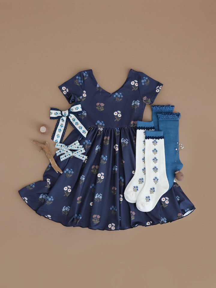 girls' navy floral print v-neck twirl dress with matching ivory and blue floral accessories