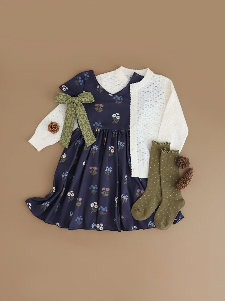 girls' navy floral fall twirl dress with v-neck design paired with ivory pointelle cardigan and olive green socks and bow