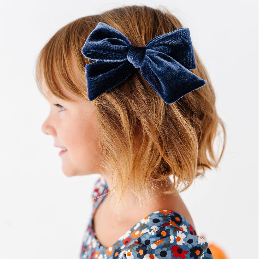 little girl with clip in navy velvet hair bow