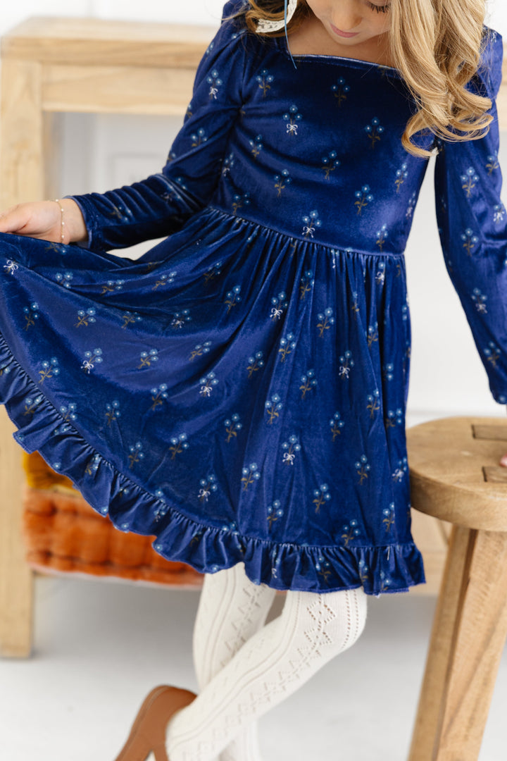 little girl in navy long sleeve velvet floral twirl with ivory open knit tights for fall