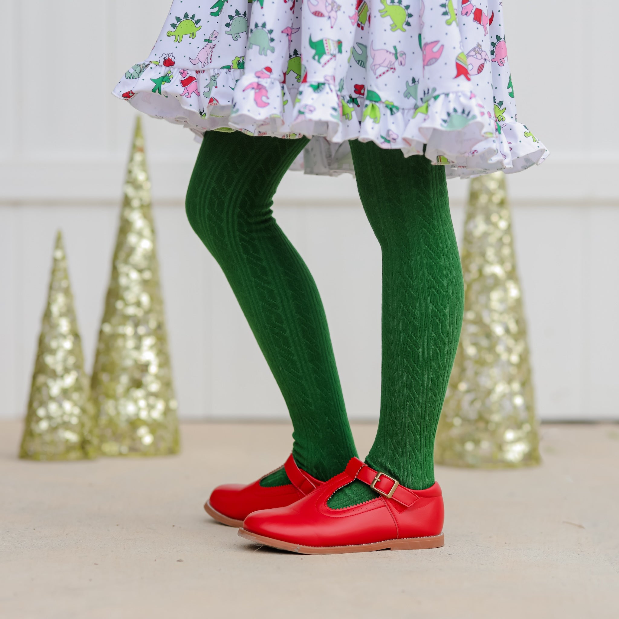 girl in noble green cable knit tights with red leather shoes and christmas dress