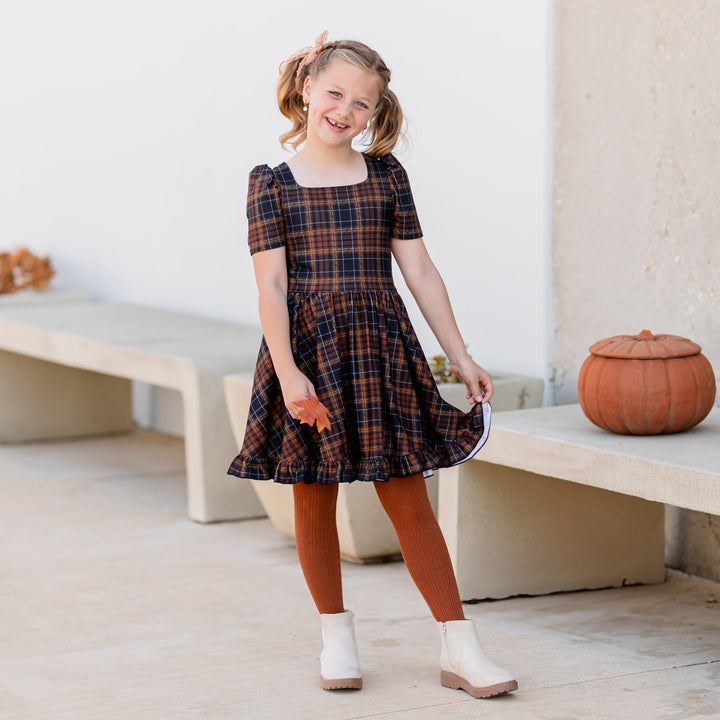 girls harvest twirl dress in black and brown plaid with matching brown cable knit tights and sheer bow 