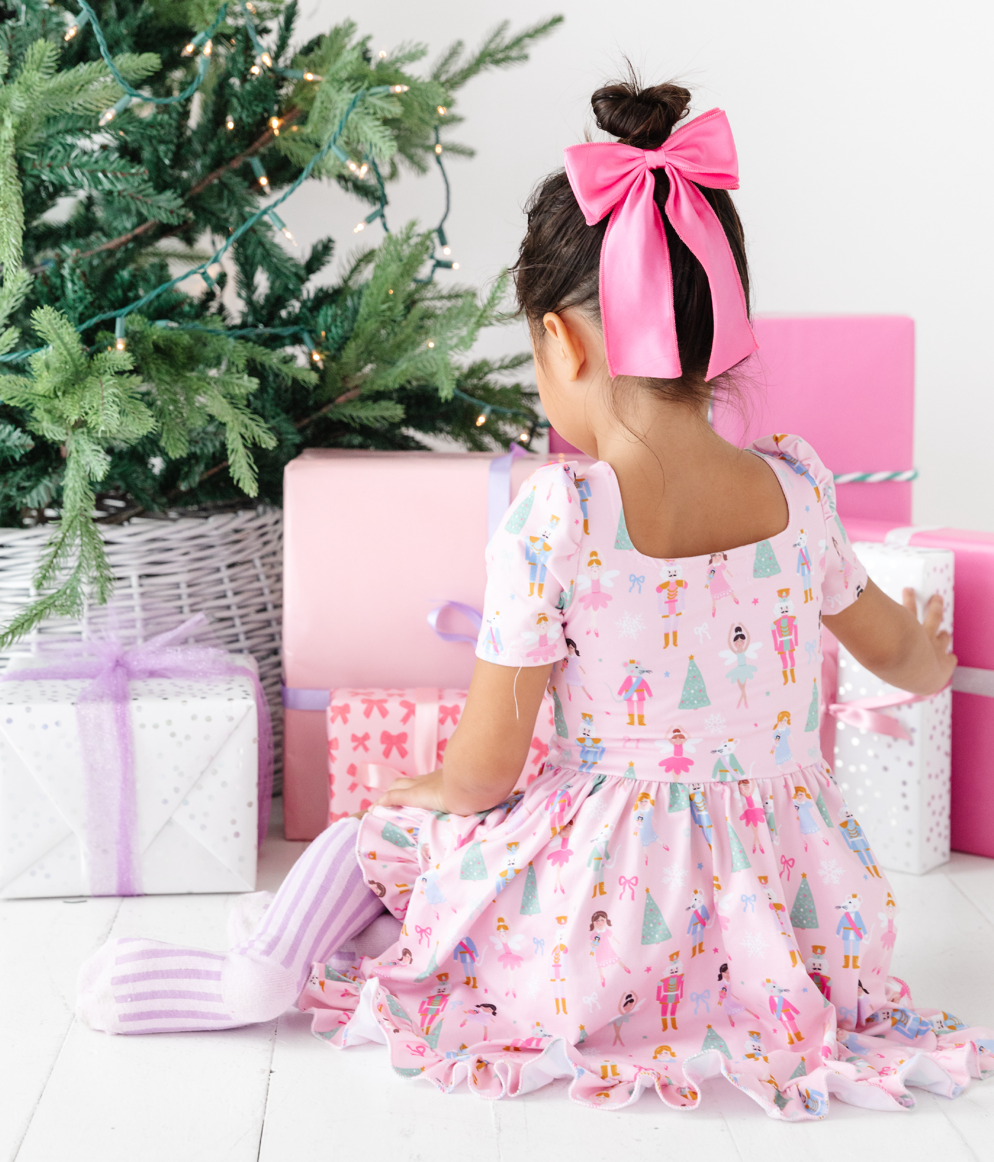 nutcracker print pink dress for girls with matching pink satin hair bow and knee high socks