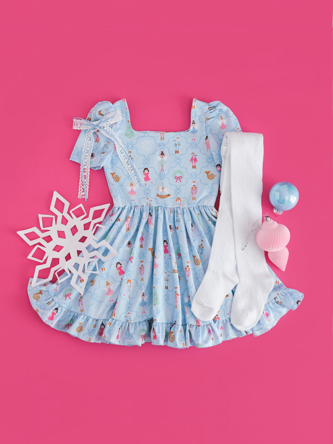 girls' blue nutcracker short sleeve twirl dress paired with white lace ribbon hair bow and white open knit tights