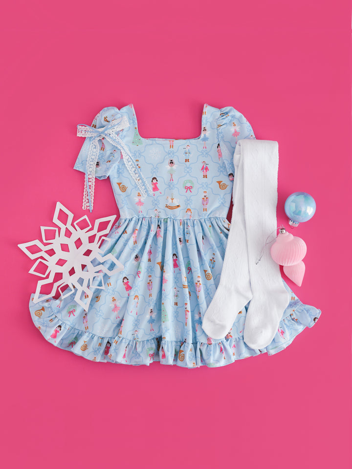 girls' blue nutcracker short sleeve twirl dress paired with white lace ribbon hair bow and white open knit tights