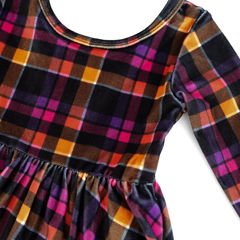 detail photo of Halloween velvet plaid dress in shades of pink, purple, orange and black