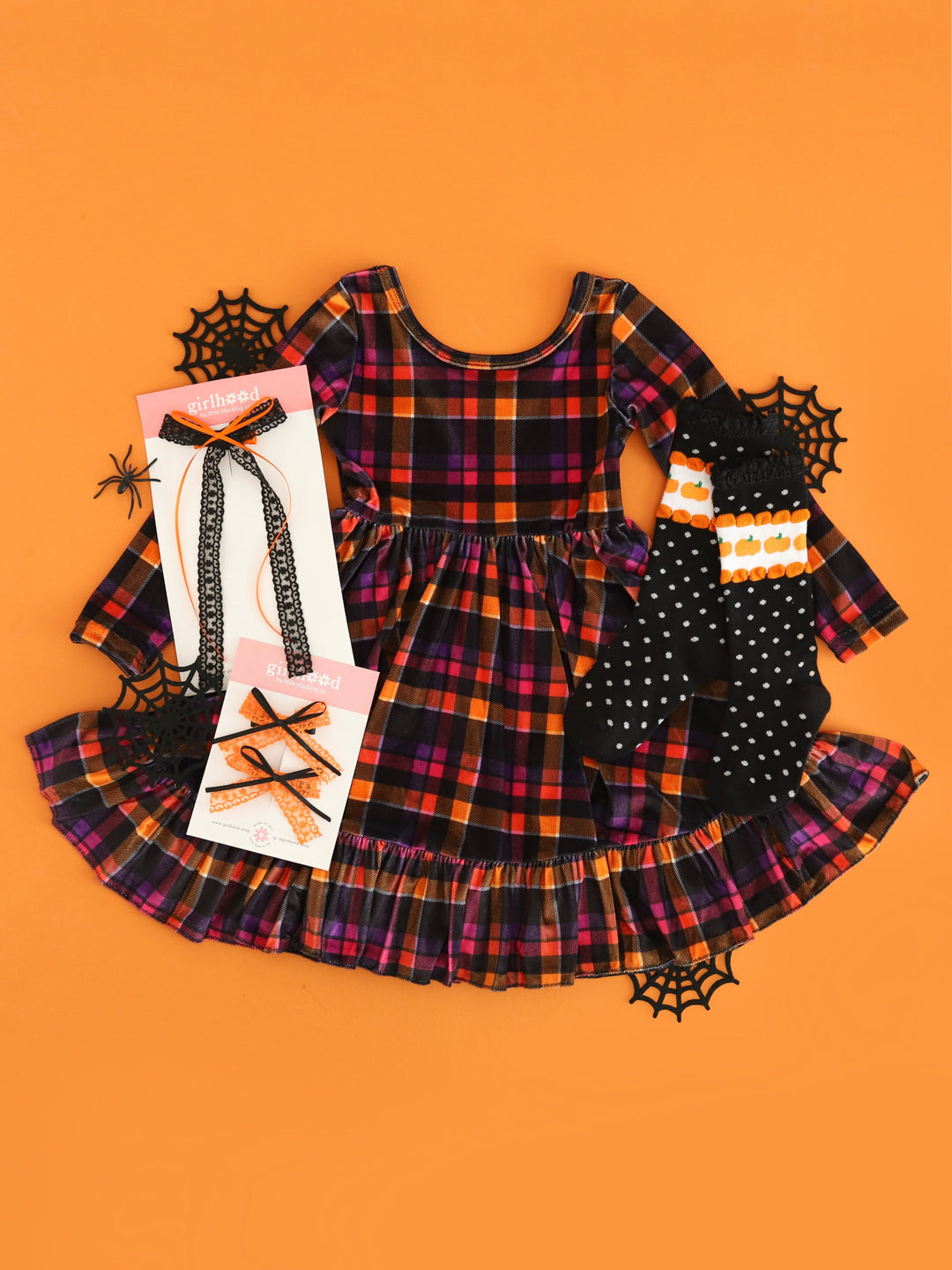 girls' long sleeve velvet twirl dress in orange, pink, purple and black plaid styled with pumpkin dot knee high socks and matching lace and ribbon bows in orange and black