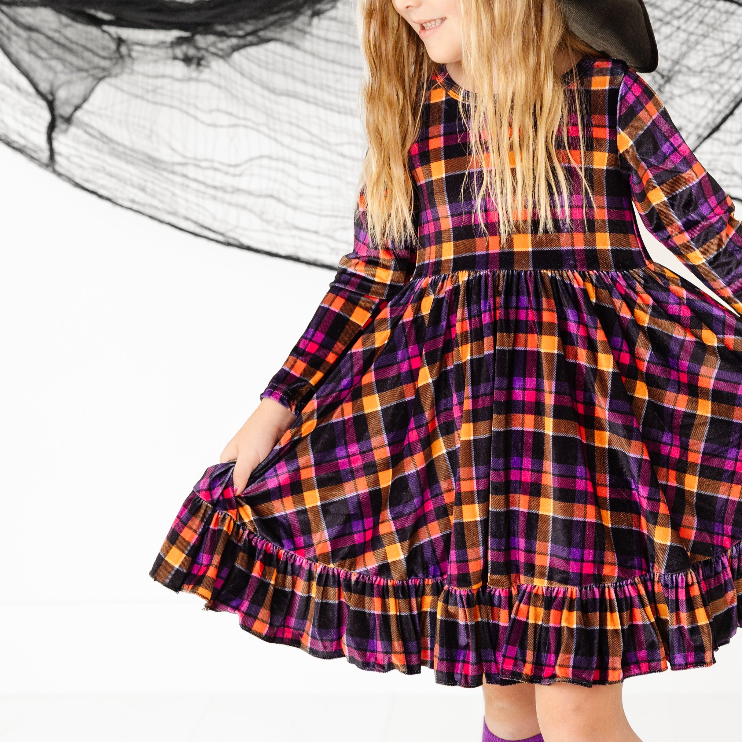 little girl in long sleeve velvet plaid twirl dress in Halloween colors