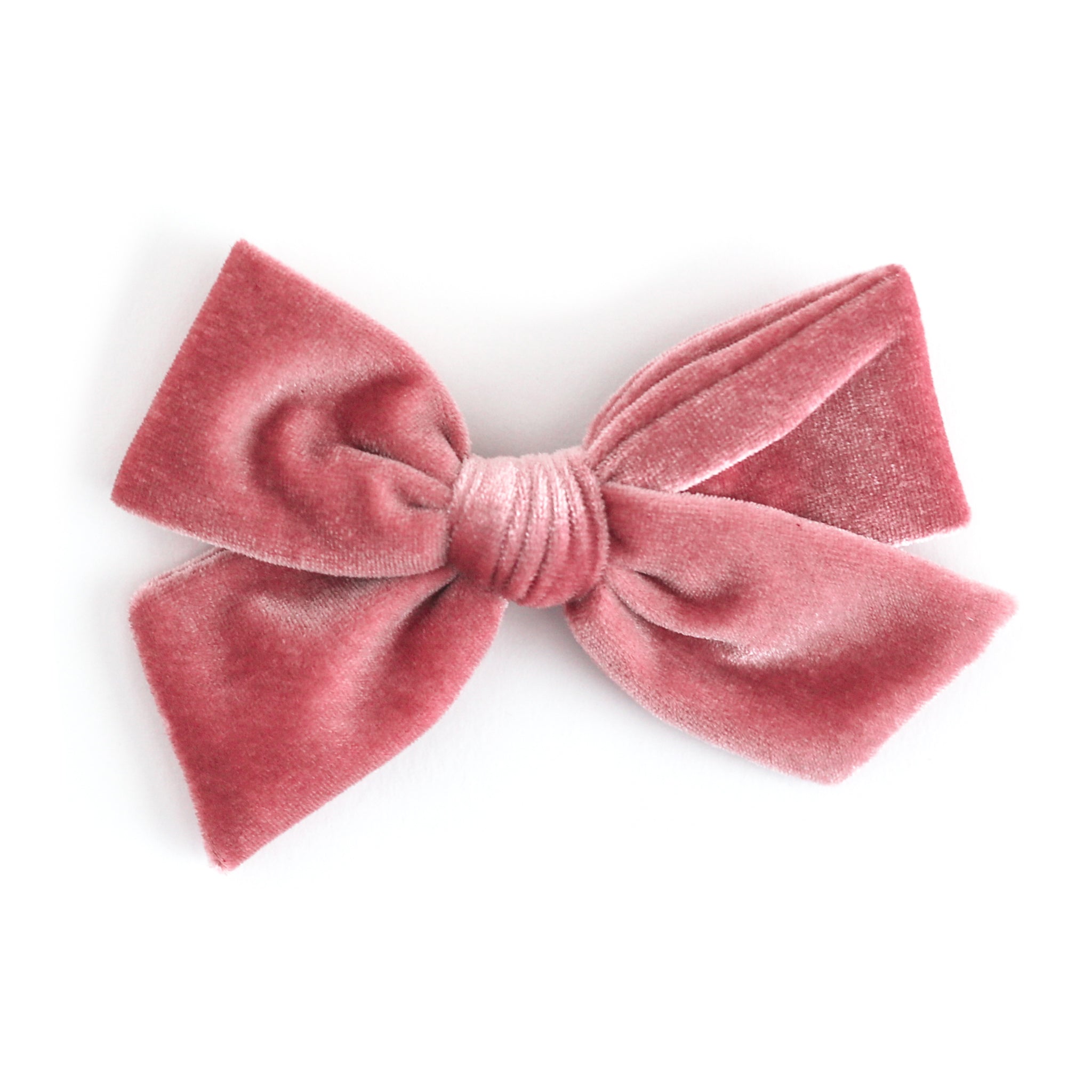 A dusty rose velvet bow hair clip on a clean white background.
