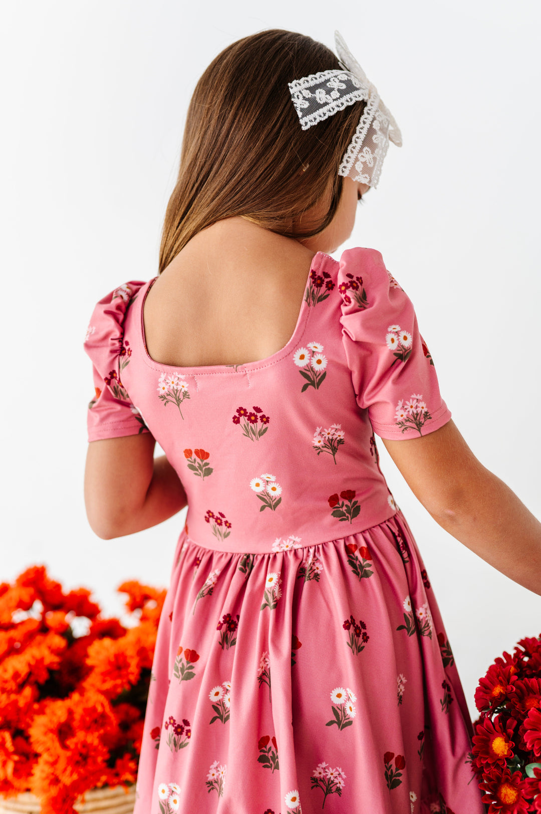 little girl showing square back neckline of fall pink floral twirl dress