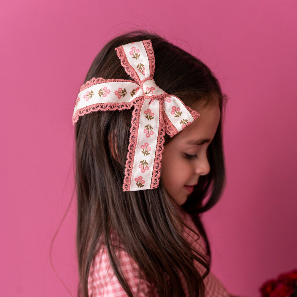 little girl in pink posie print hair bow with pink lace trim for fall