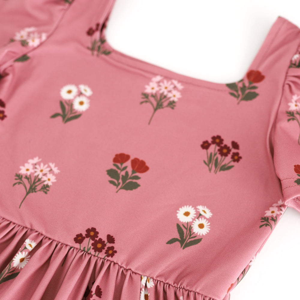 detail photo of square neck twirl bodice in light mauve with burgundy, ivory and rust flower bouquets