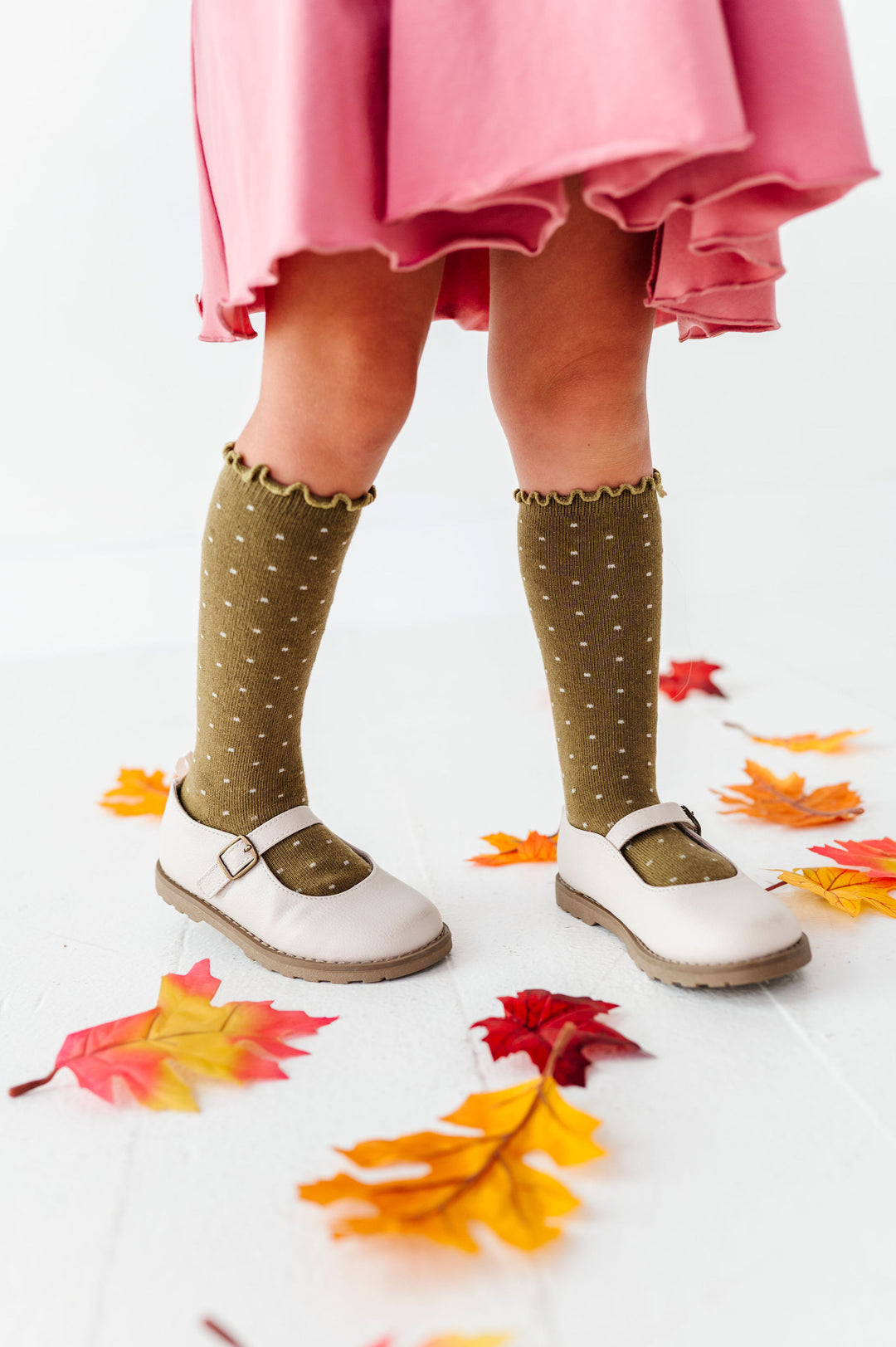 girl wearing olive green knee high socks with lettuce trim top