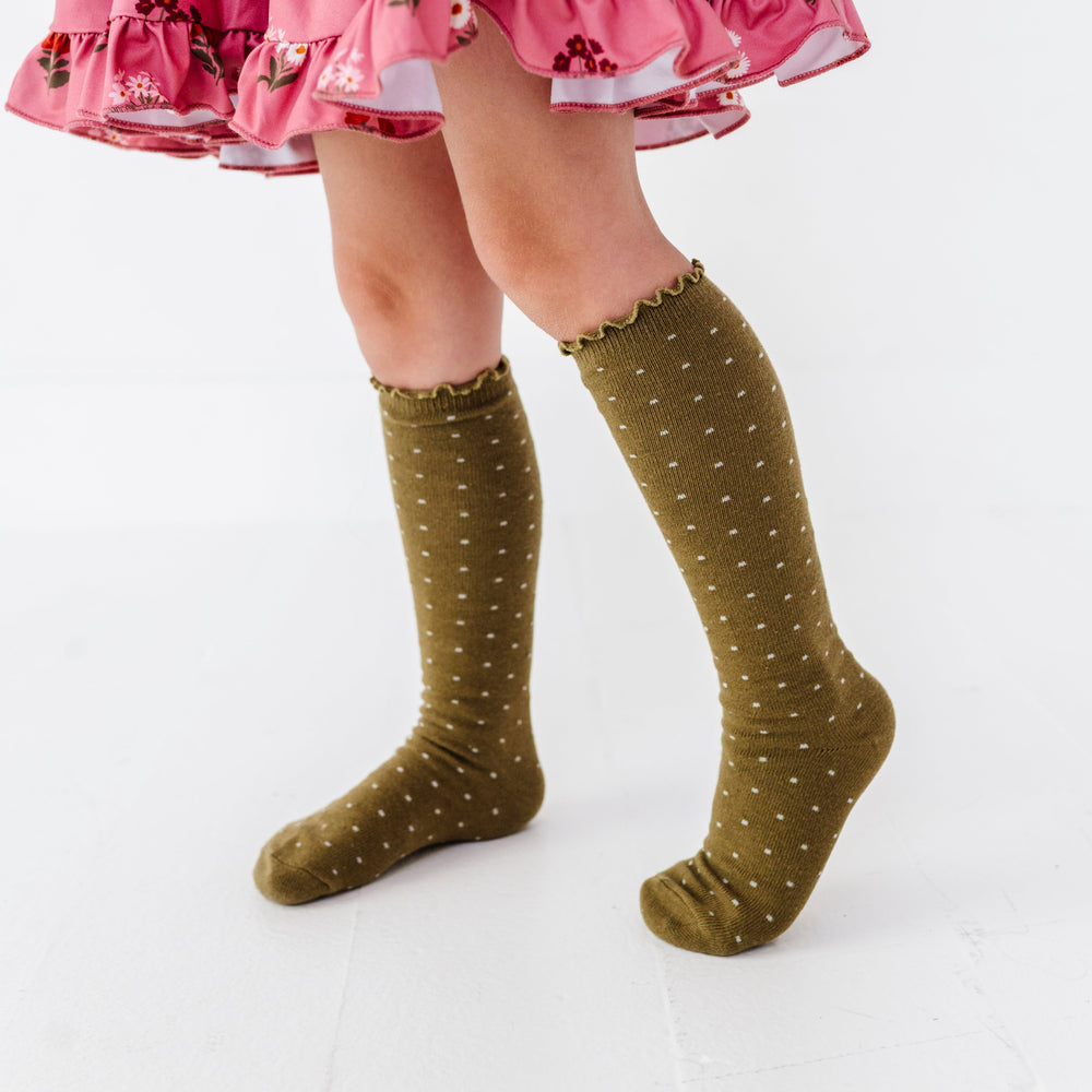 little girl in olive green lettuce trim knee high socks with tiny ivory dots paired with pink fall floral dress
