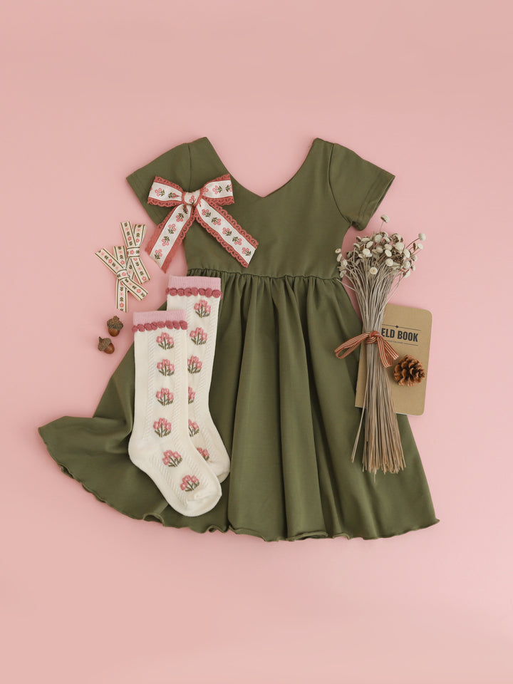 girls' olive green v-neck twirl dress with short sleeves styled with ivory and pink fall floral knee socks and matching hair bows