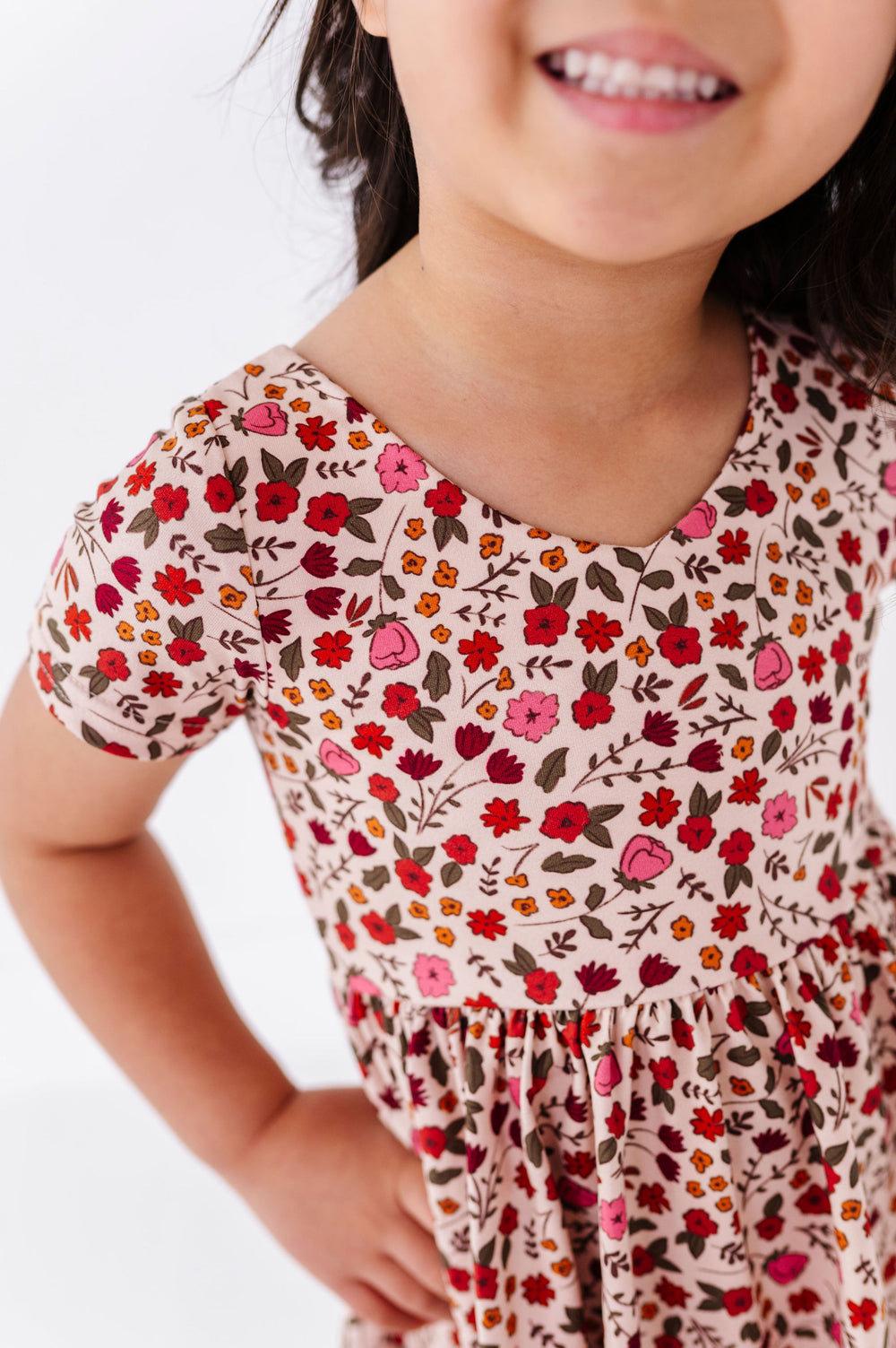 close-up detail of fall floral dress on little girl