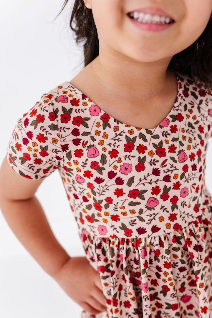 close-up detail of fall floral dress on little girl