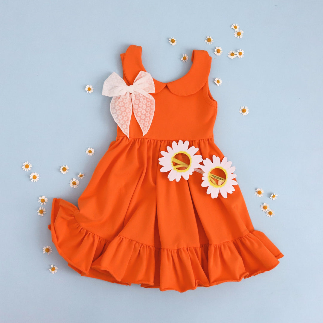 girls' bright orange cotton twirl dress with cute white floral hair bow