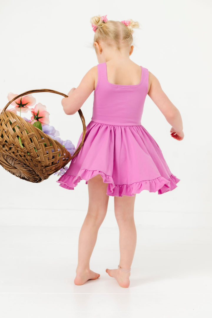 little girl with floral basket twirling in orchid purple cotton blend sleeveless summer twirl dress