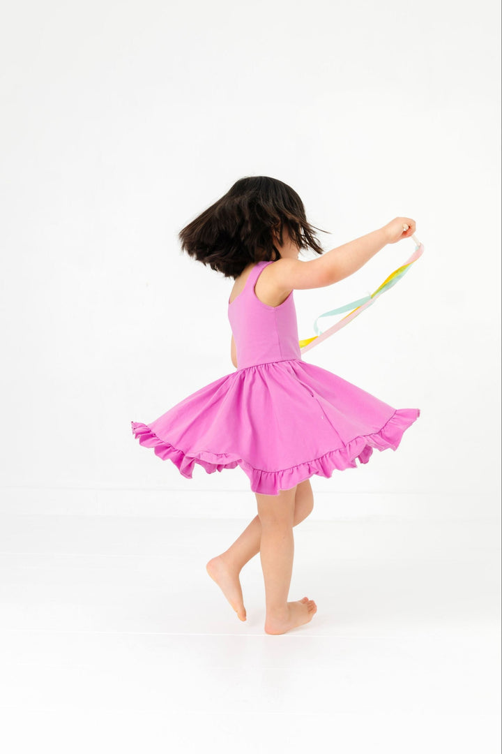 little girl twirling with streamers in sleeveless solid orchid cotton blend twirl dress with ruffled hem