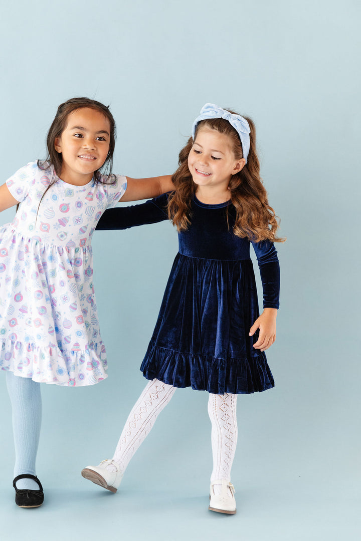 girls wearing ornament print dress and blue velvet party dress