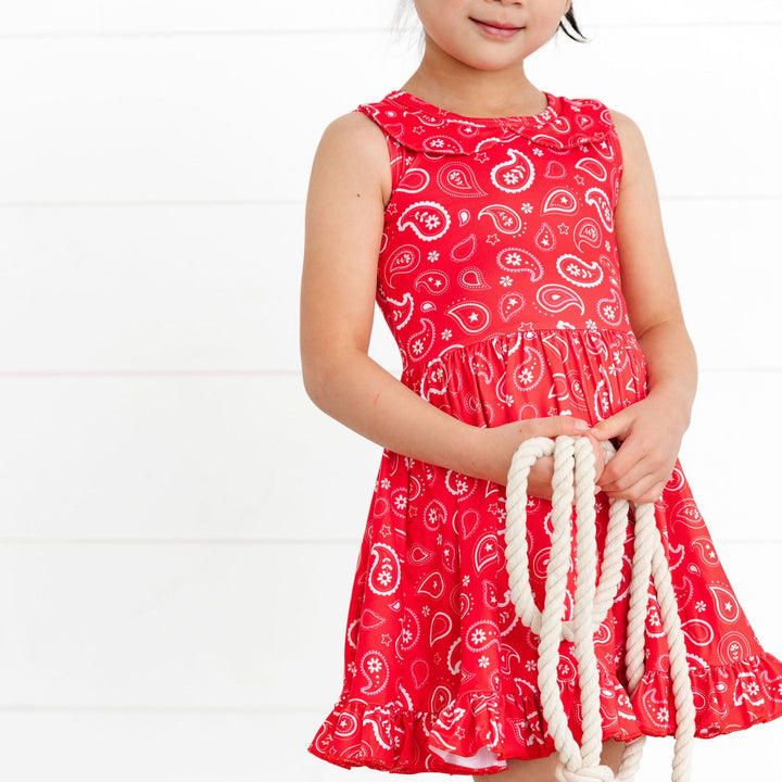 little cowgirl wearing red, pink and white paisley print tank top dress