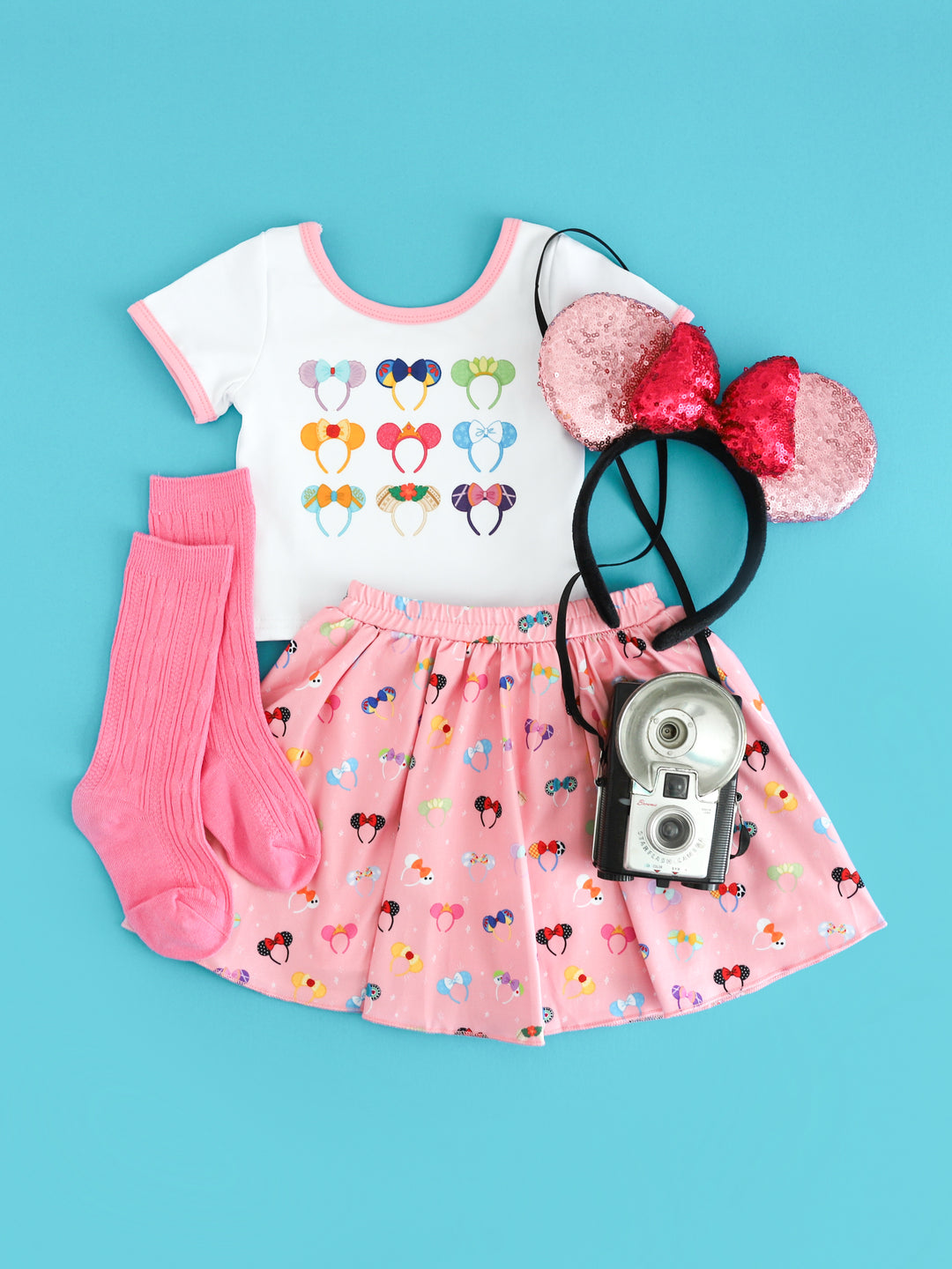 girls' white top with Disney character inspired ears print paired with  pink skort with magical ears print and pink knee high socks