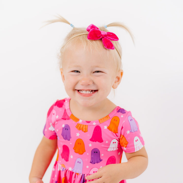 little girl in pink Halloween ghost print dress with matching hot pink velvet baby bow on soft nylon headband