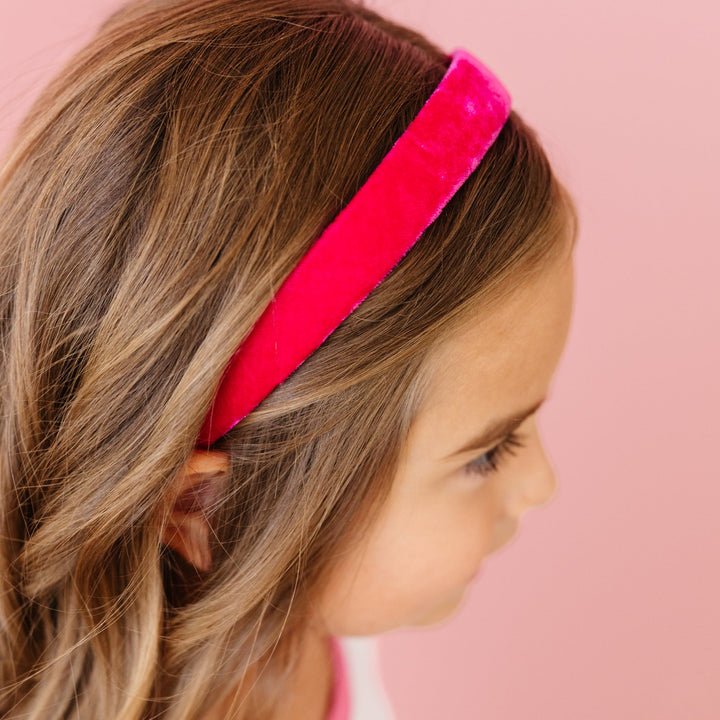 little girl in bright pink velvet headband 