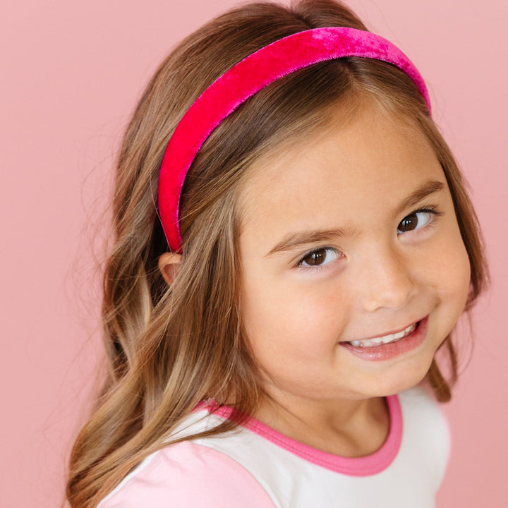 little girl in ghouly pop fitted top with pink short sleeves and matching bright pink velvet headband for pink Halloween