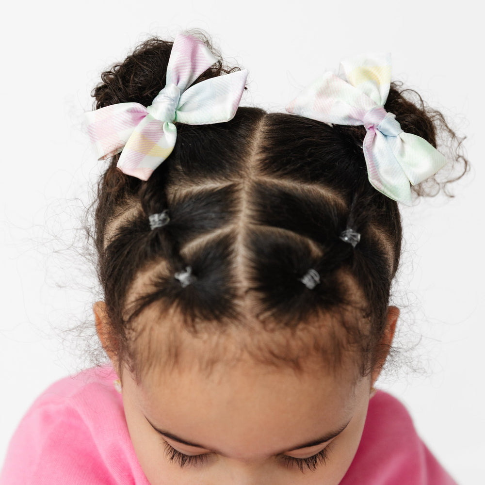 girl with high pigtail buns and pastel gingham hairbows for spring and easter