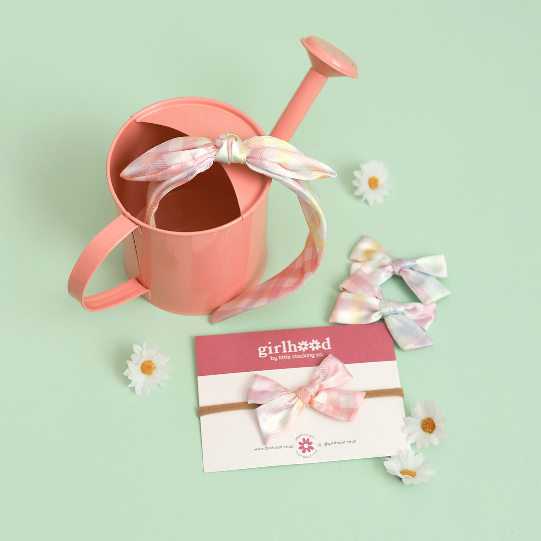 spring flatlay of girls' satin pastel gingham hair bows and headbands in various styles