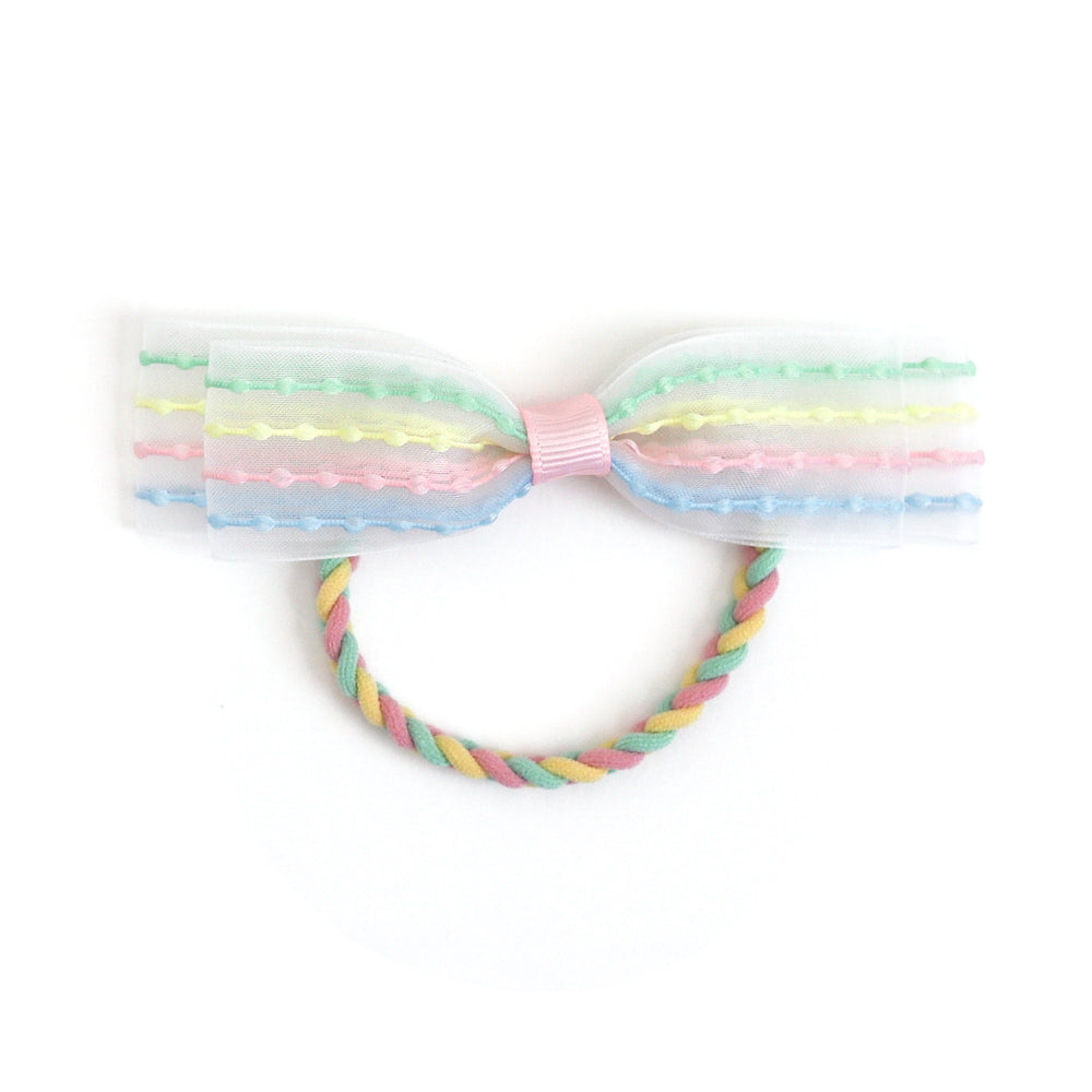 girl's pastel rainbow ponytail with braided elastic and sheer white bow with pastel bubble stripes for spring