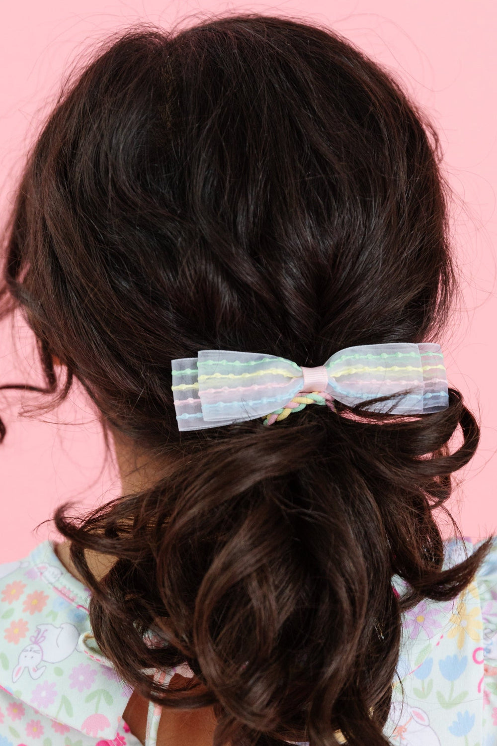 little girl wearing pastel bubble stripe ponytail to match easter floral twirl dress