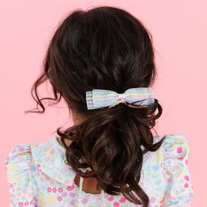 little girl wearing pastel bubble stripe ponytail to match easter floral twirl dress