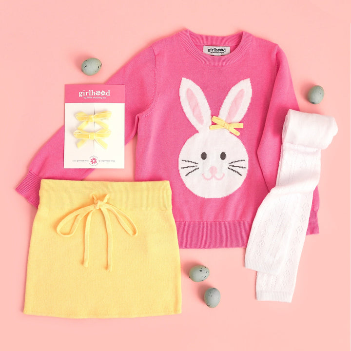 girls outfit with pink easter bunny sweater and matching yellow knit skirt, white fancy footless tights and yellow velvet pigtail bows