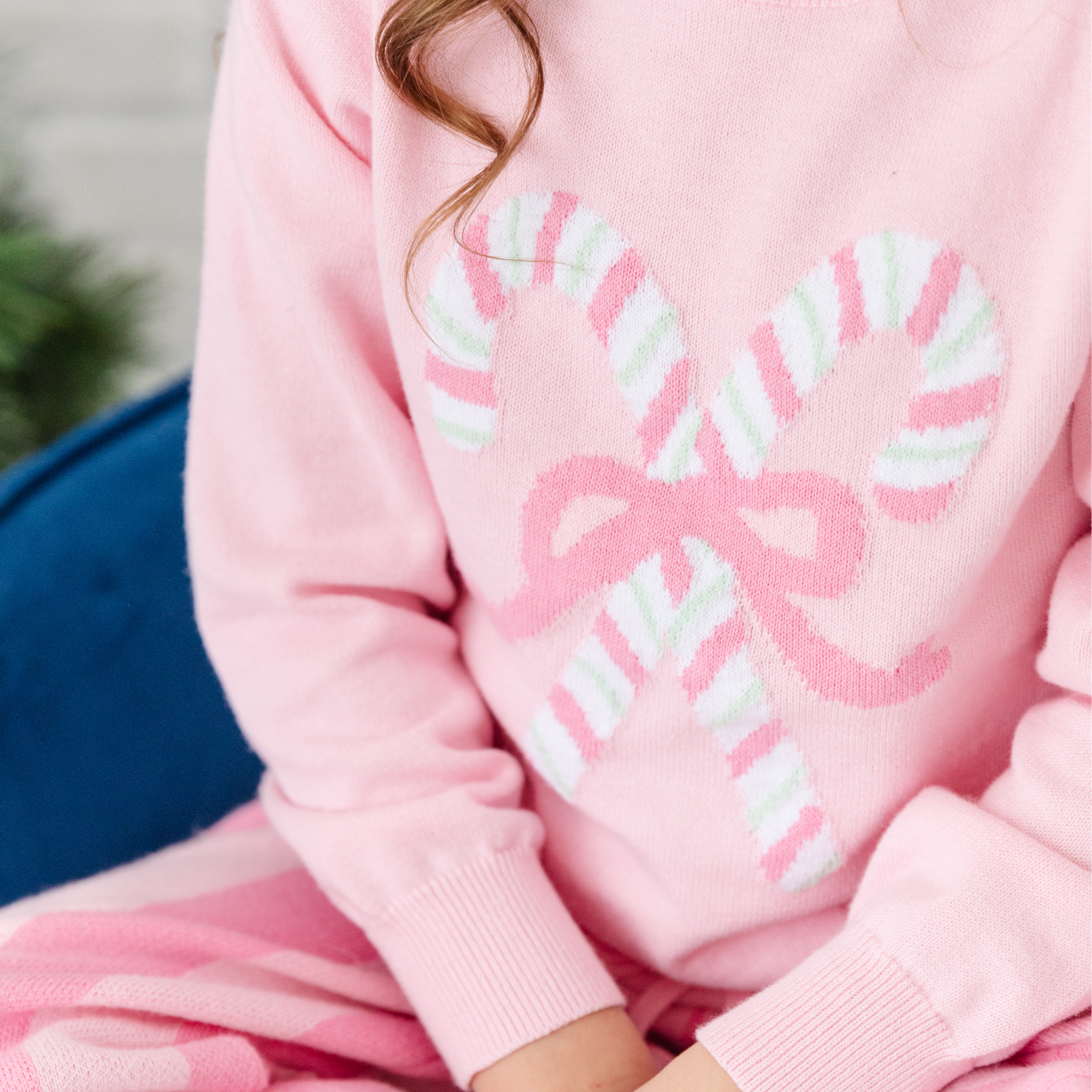 light pink sweater with pink and mint striped candycanes closeup