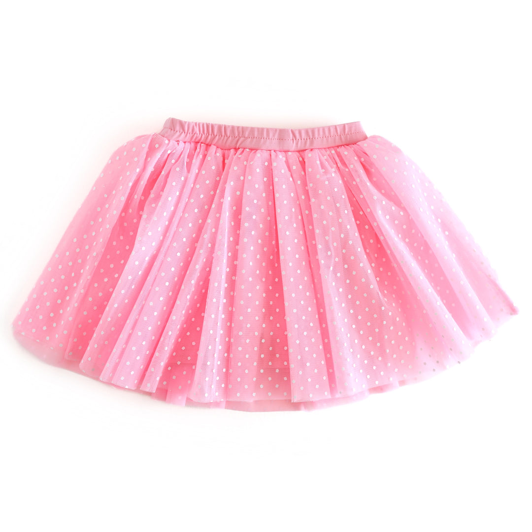 Pink tutu skirt with white polka dots on a white background