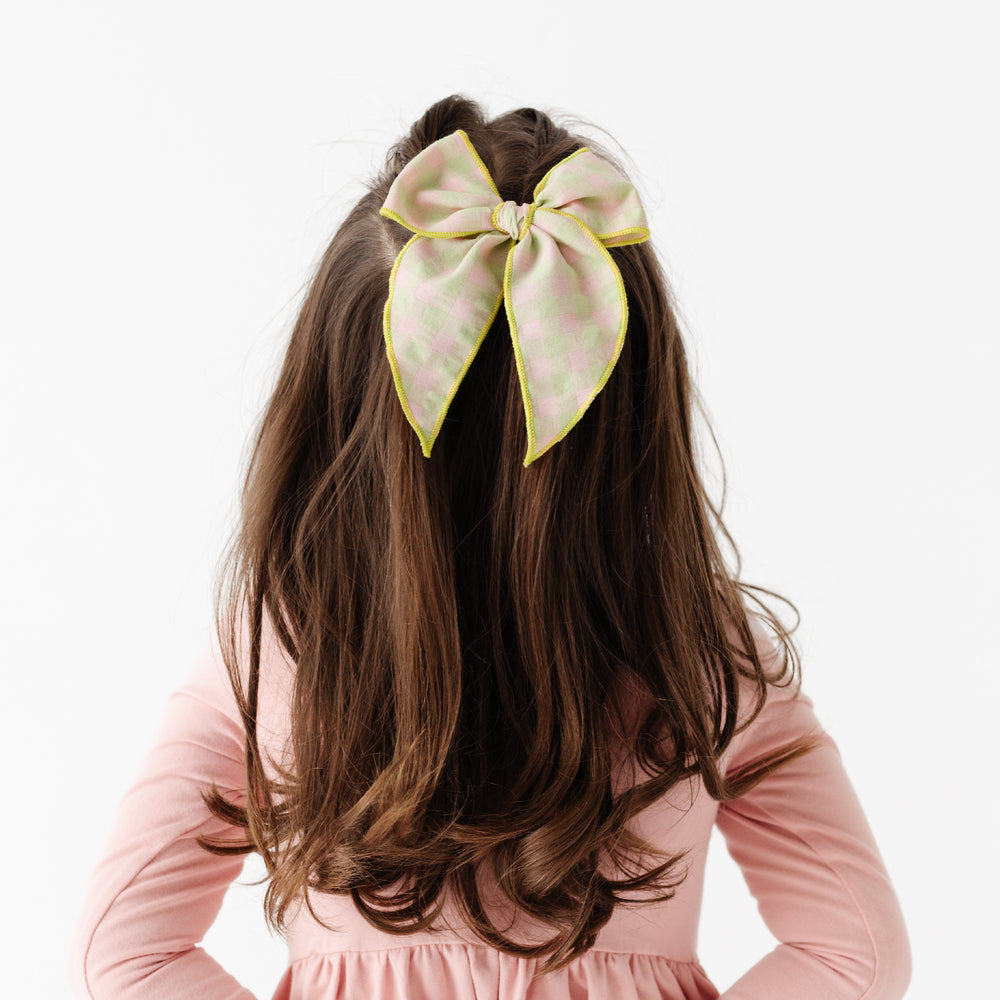 girl wearing green and pink gingham hair bow with kiwi green trim