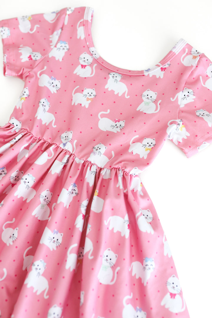 detail photo of girls pink short sleeve twirl dress with white kitten print