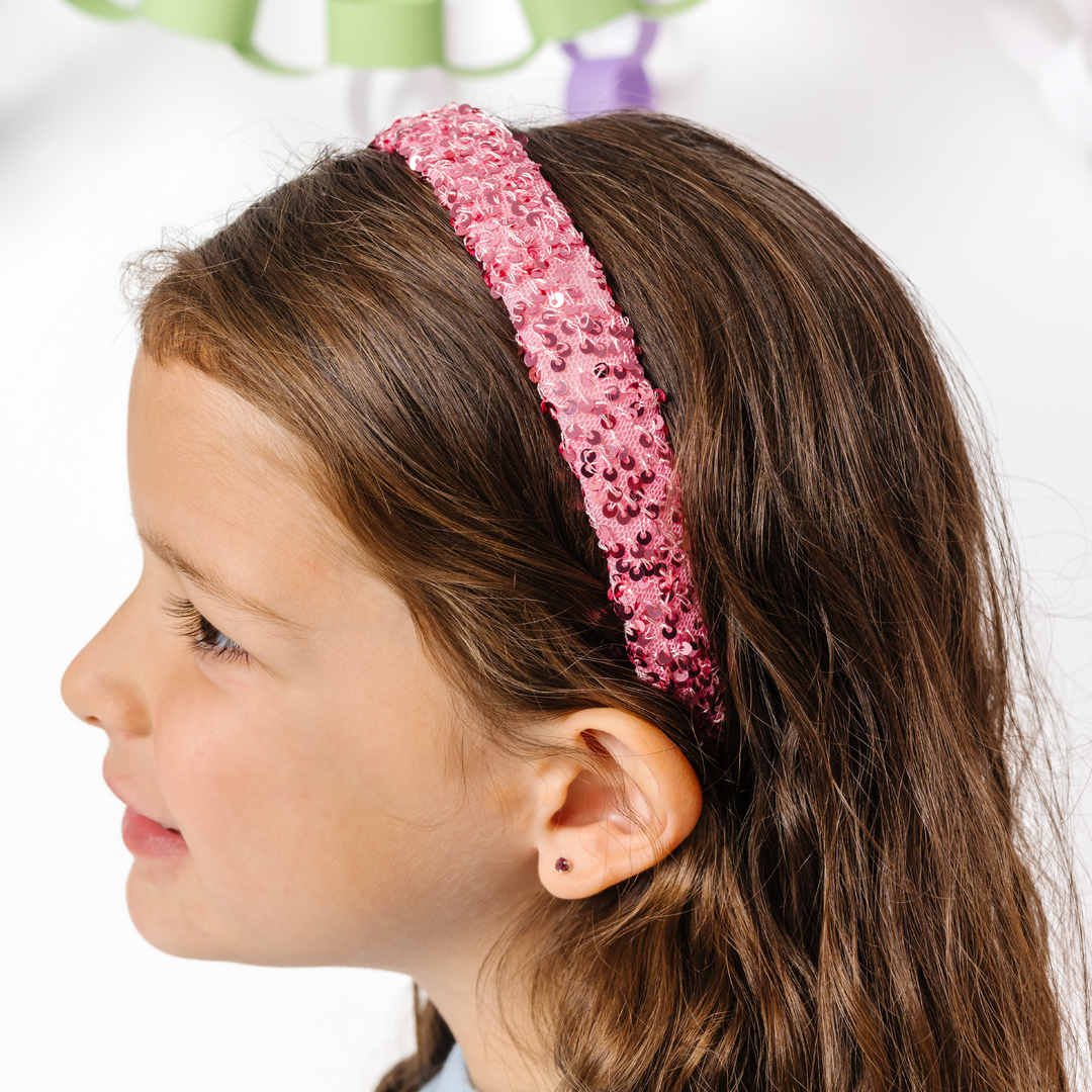 little girl in pink sequin headband for christmas