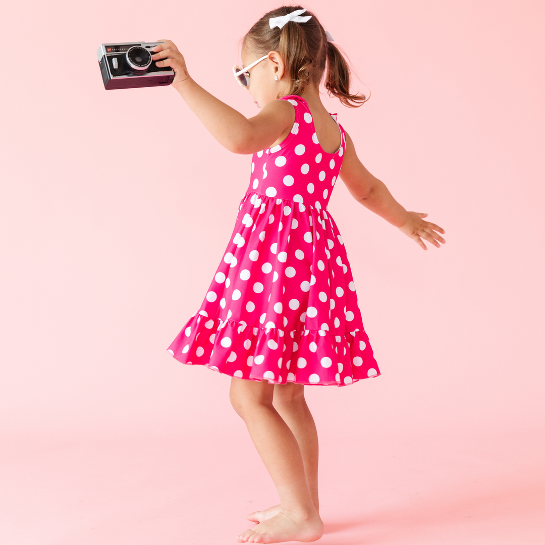 little girl twirling in hot pink and white dots summer twirl dress