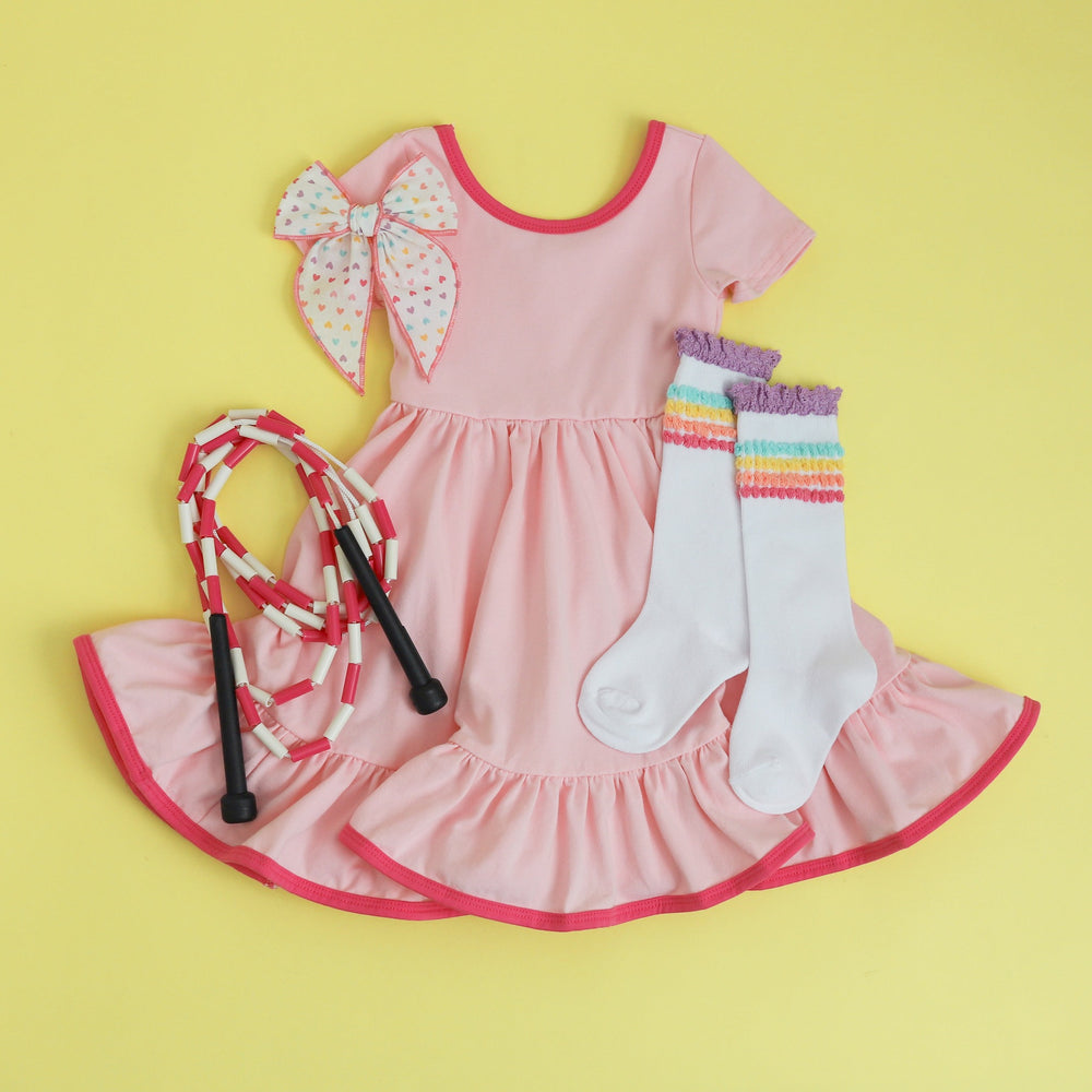girls' pink cotton dress outfit with rainbow heart hair bow and pastel bubble knee high socks