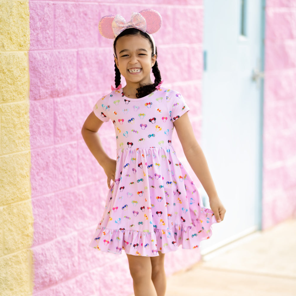 little girl wearing pink magical ears dress with sparkly minnie mouse ears