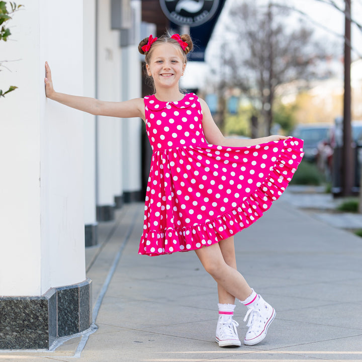 little girl wearing hot pink polka dot dress inspired by Minnie