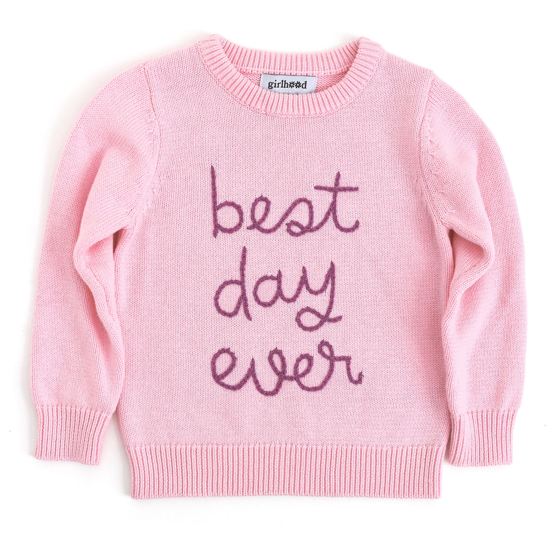 pink chunky knit sweater with embroidered "best day ever" text in sparkly purple