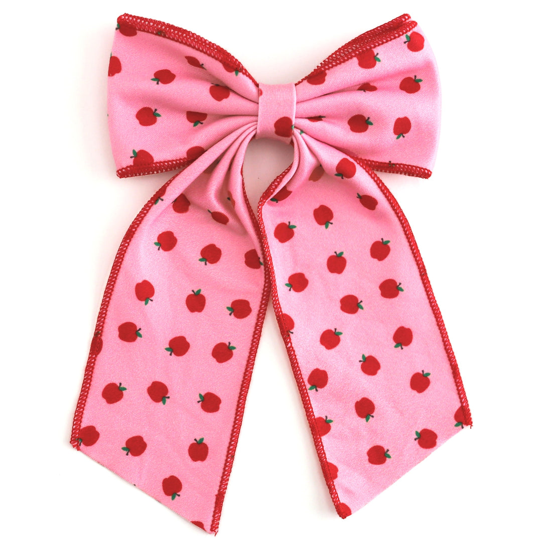 girls' pink oversized double hair bow with red apple print and red trim to match back to school apple print dress