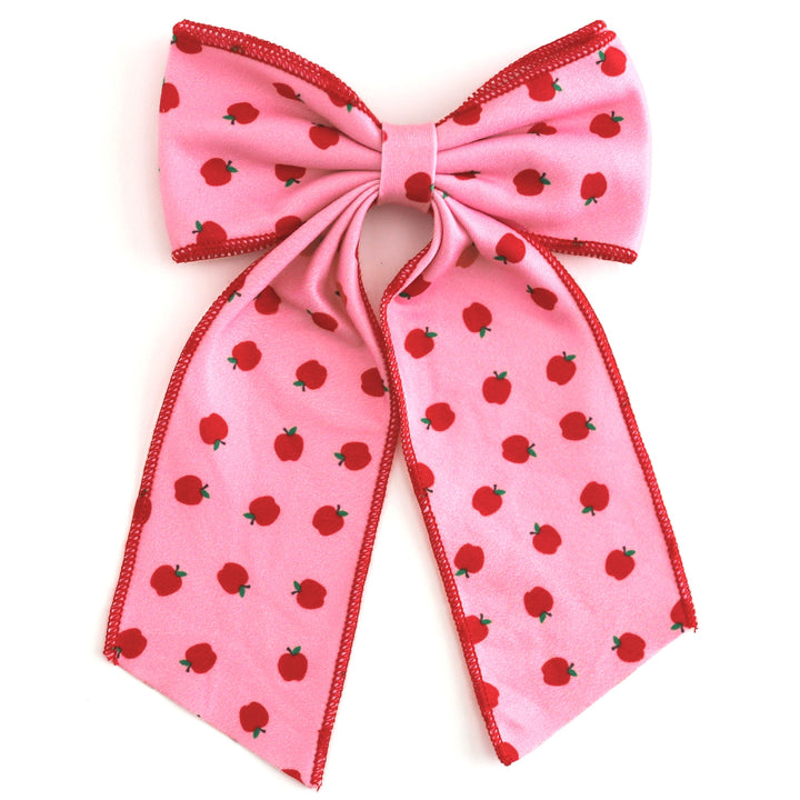 girls' pink oversized double hair bow with red apple print and red trim to match back to school apple print dress