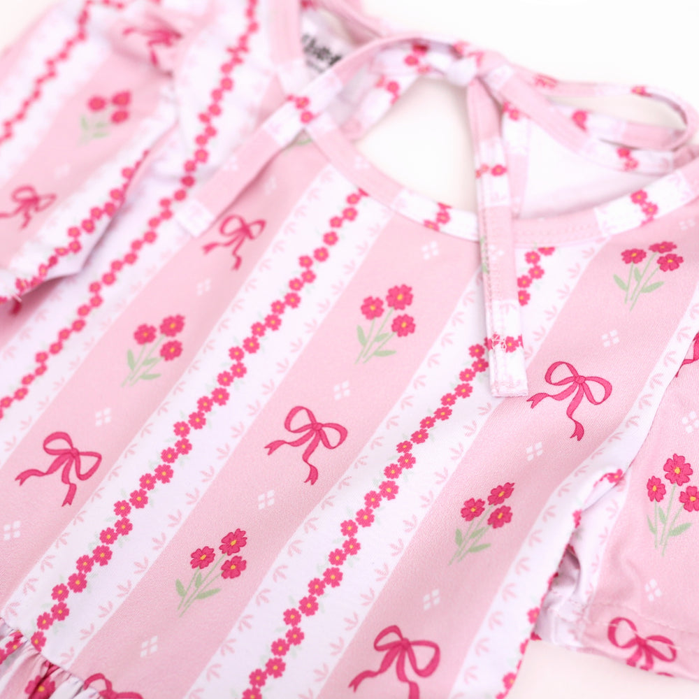 closeup of pink spring wallpaper print with pink flowers and bows